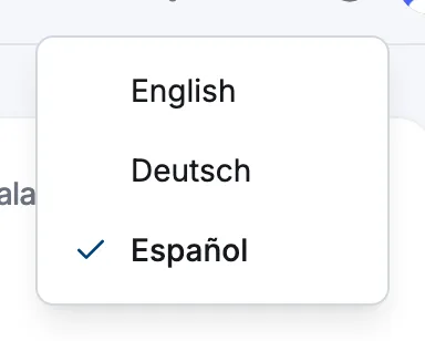La barra superior del dashboard con el menú de idioma del globo abierto, mostrando English, Deutsch y Español